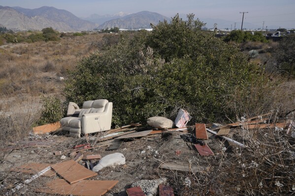 Household trash is seen illegally dumped on the San Gabriel River trail in Irwindale, Calif., Friday, Jan. 31, 2025, near Lario Park. (AP Photo/Damian Dovarganes)